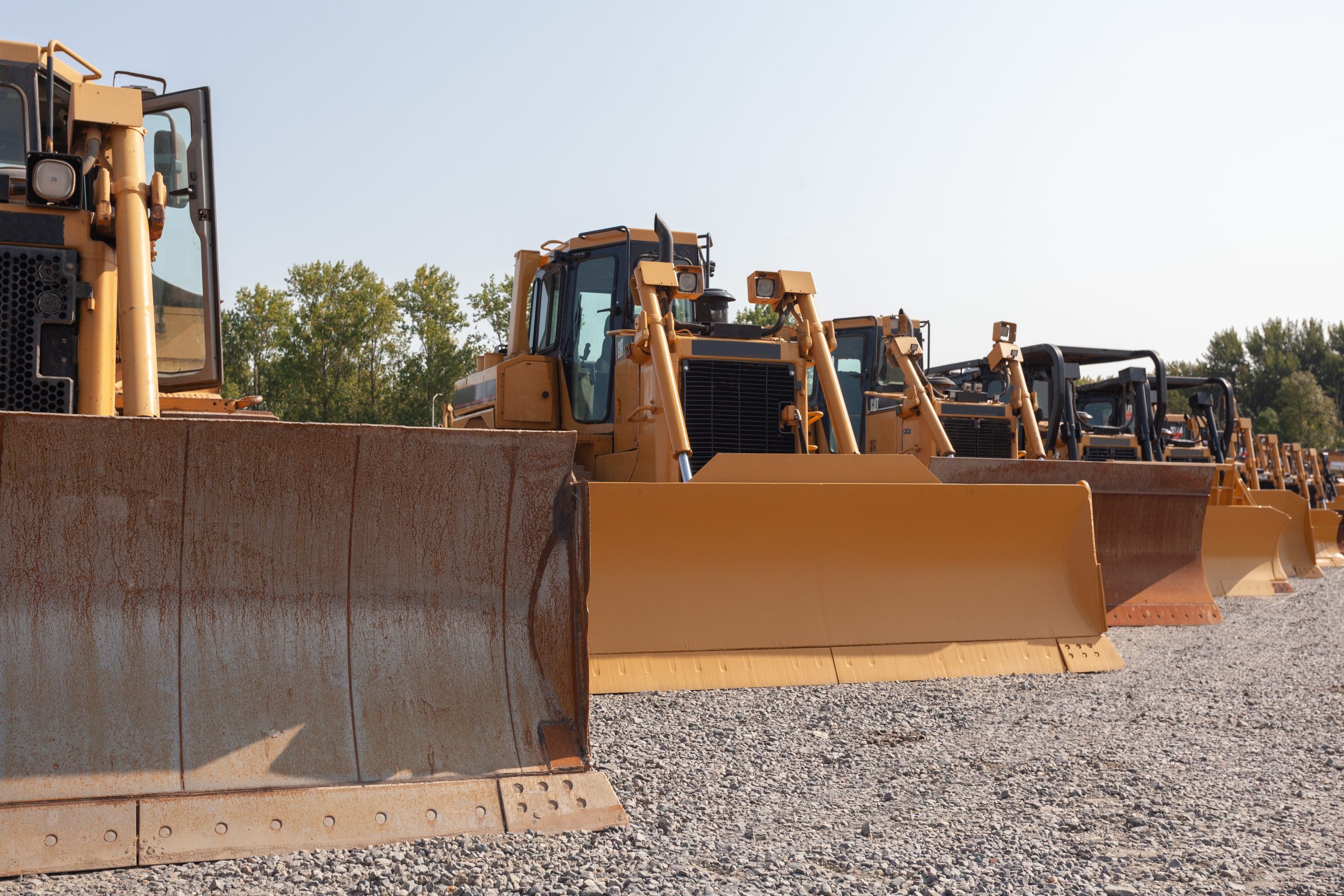 A row of bulldozers in a construction site